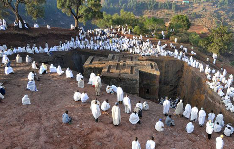 Worshippers gathered around a historic Ethiopian rock-hewn church